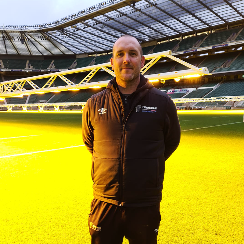 Jim Buttar, Head Groundsman Twickenham Stadium posing in front of an SGL HPS grass grow light.